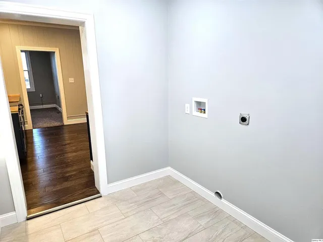 a view of hallway with wooden floor