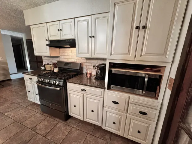 a kitchen with windows and cabinets