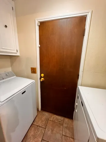 a bed room with a bed and a chandelier