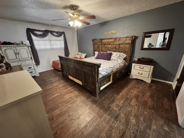 a bed room with furniture and flat screen tv