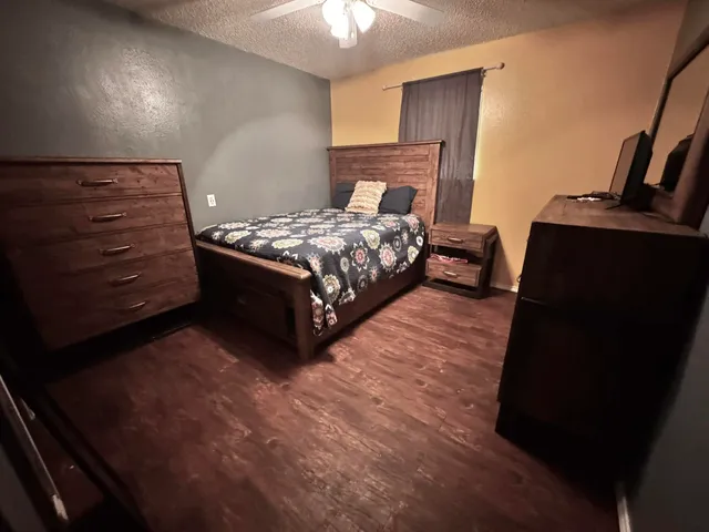 a bathroom with a granite countertop toilet sink and mirror