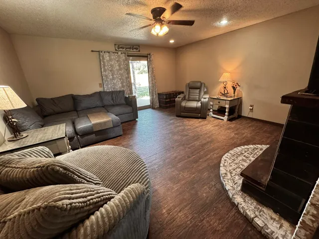 a living room with furniture ceiling fan and a rug