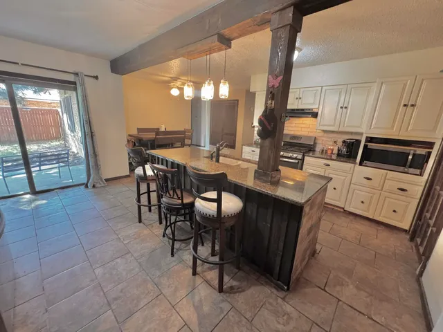 a kitchen with a sink stove and cabinets