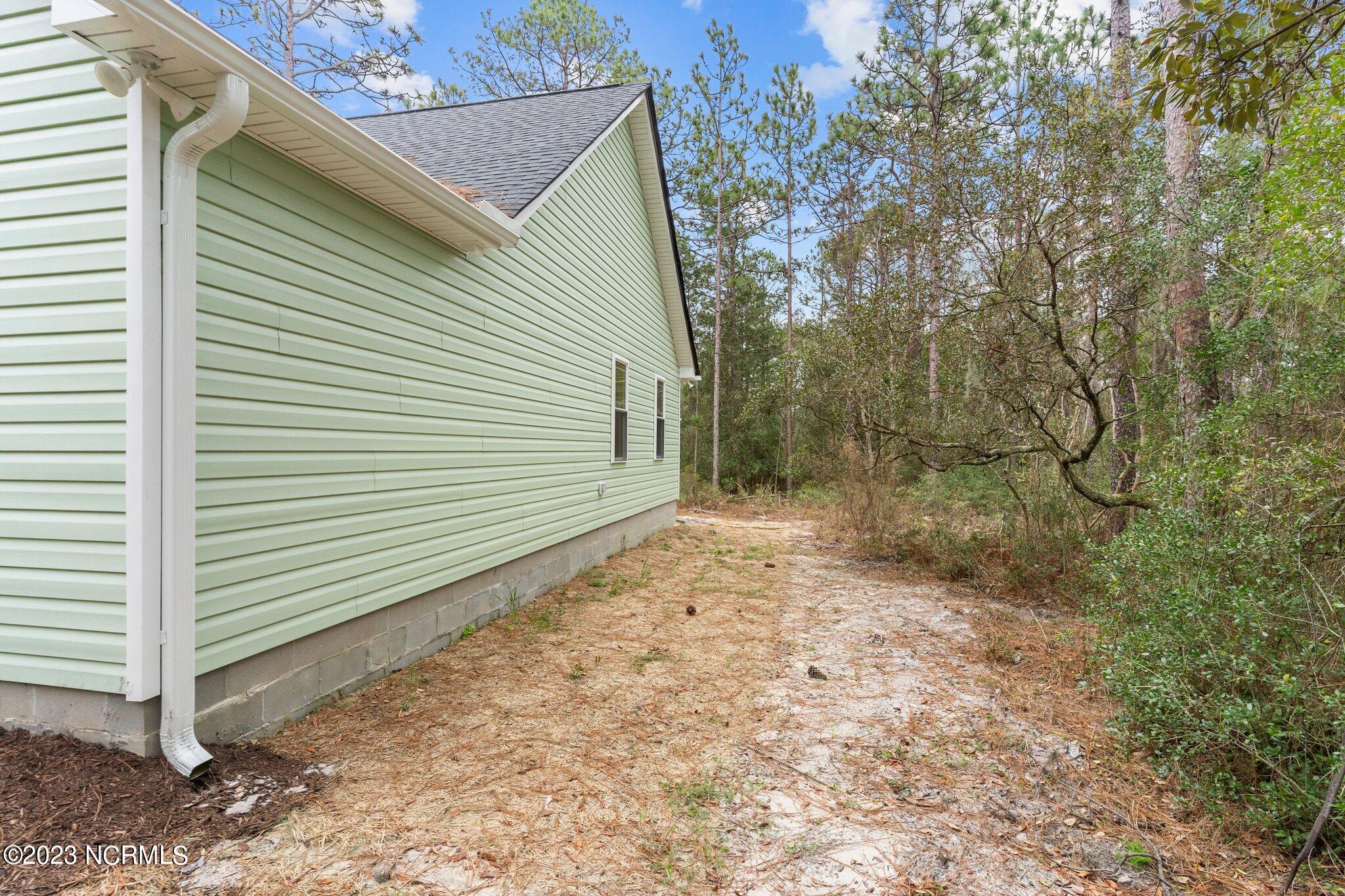 68 Knox Road Southport, NC 28461 - Photo 15 of 53 Wooded Back Yard with Lovely Live Oaks