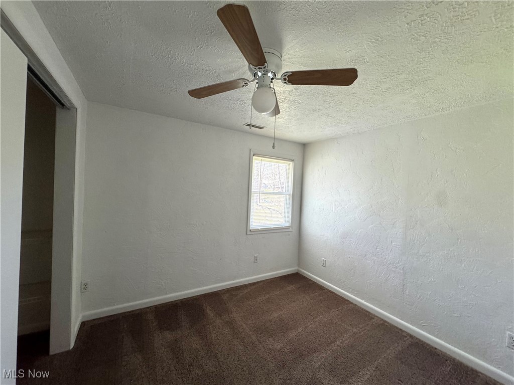 8961 Herbert Road Canfield, OH 44406 - Photo 15 of 26 Empty room featuring carpet floors, a textured ceiling, baseboards, and visible vents