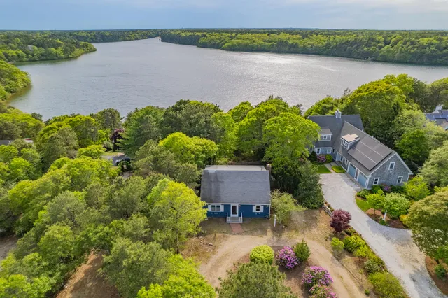 an aerial view of a house with a lake view
