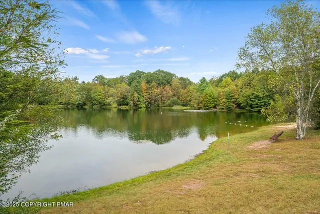 a view of a lake with houses in the back