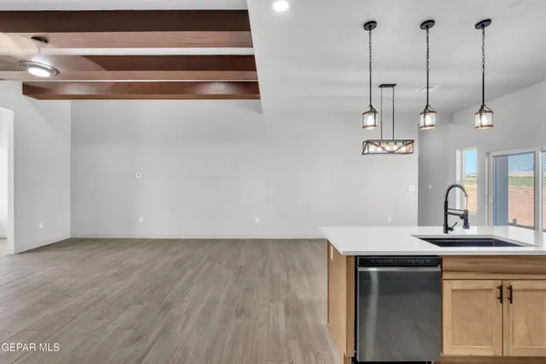 a view of a room with wooden floor