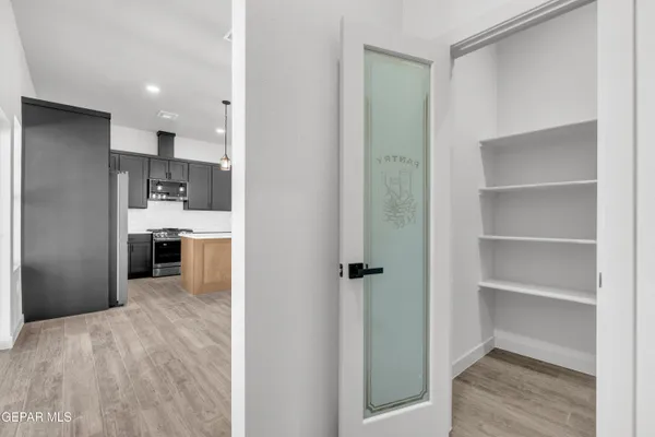 a view of a kitchen with a refrigerator and a sink