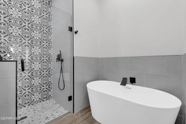 a bathroom with a bathtub and shower