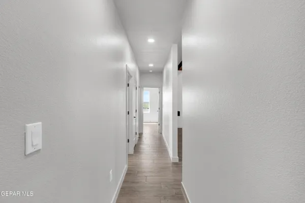 a view of a hallway with wooden floor