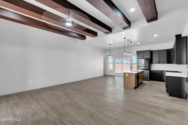 a view of kitchen and kitchen with stainless steel appliances
