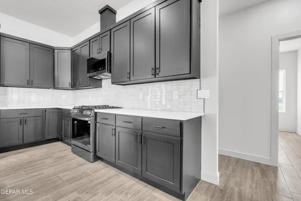 a kitchen with stainless steel appliances granite countertop a sink and cabinets