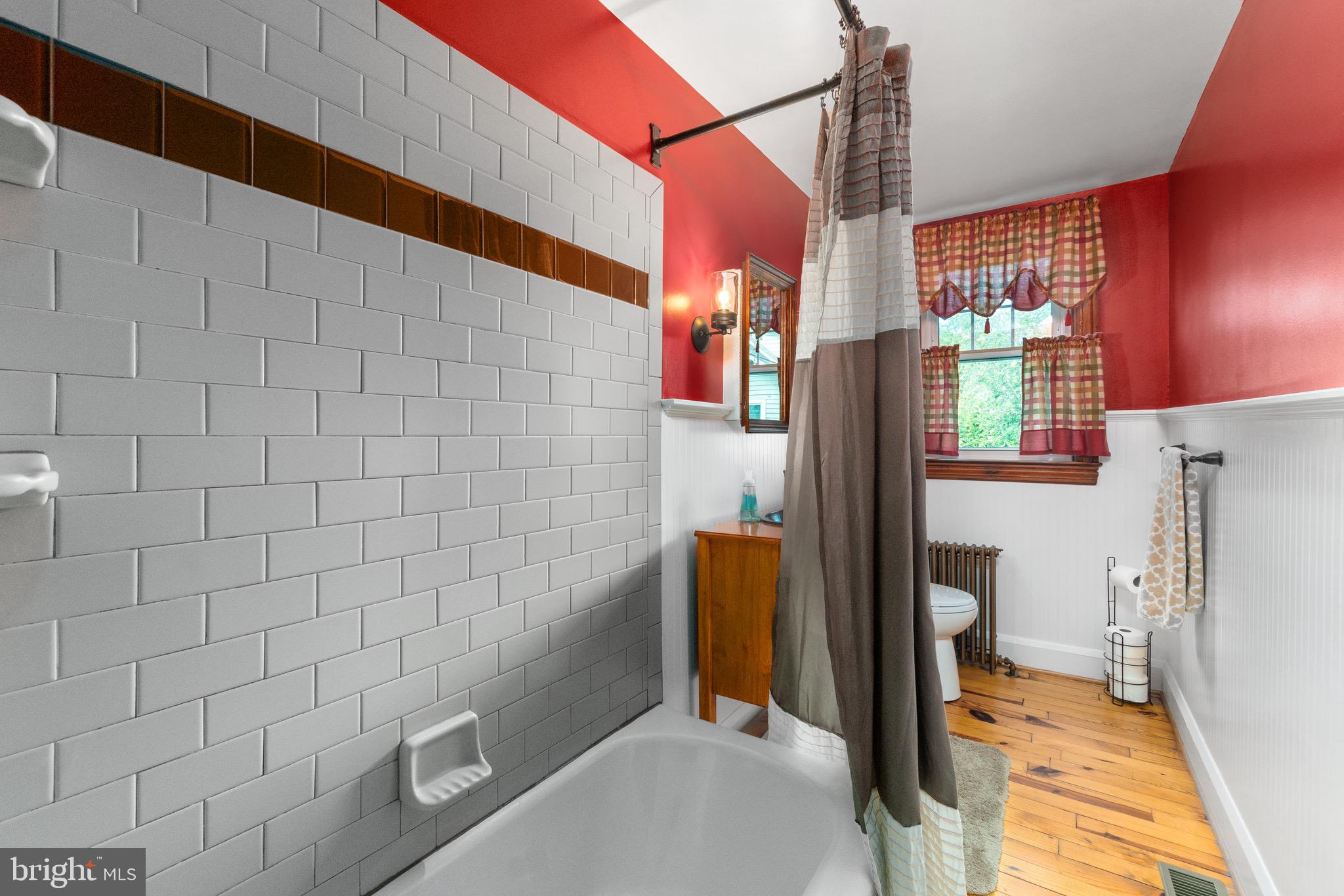 2017 Drummond Road Baltimore, MD 21228 - Photo 20 of 50 Subway style accents the tub area + pine floor