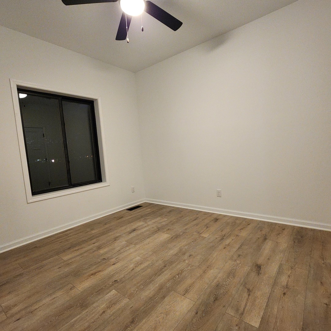 422 View Street Ottawa, IL 61350 - Photo 11 of 22 an empty room with wooden floor and natural light