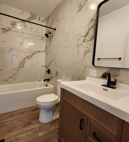 a bathroom with a sink a toilet and a bathtub