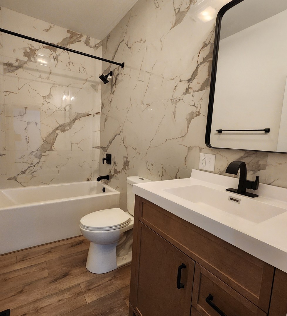 422 View Street Ottawa, IL 61350 - Photo 12 of 22 a bathroom with a sink a toilet and a bathtub