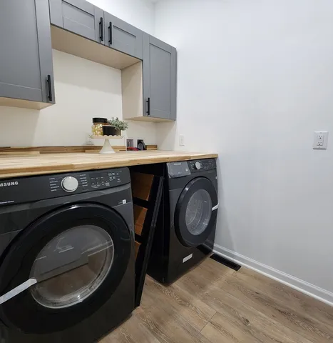 a utility room with sink dryer and washer