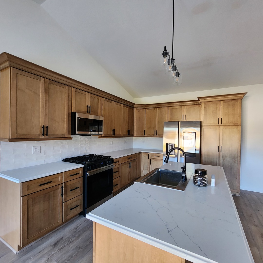 422 View Street Ottawa, IL 61350 - Photo 6 of 22 a kitchen with stainless steel appliances granite countertop a sink dishwasher stove top oven and cabinets with wooden floor