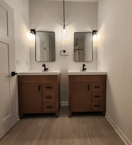 a bathroom with a double vanity sink and mirror