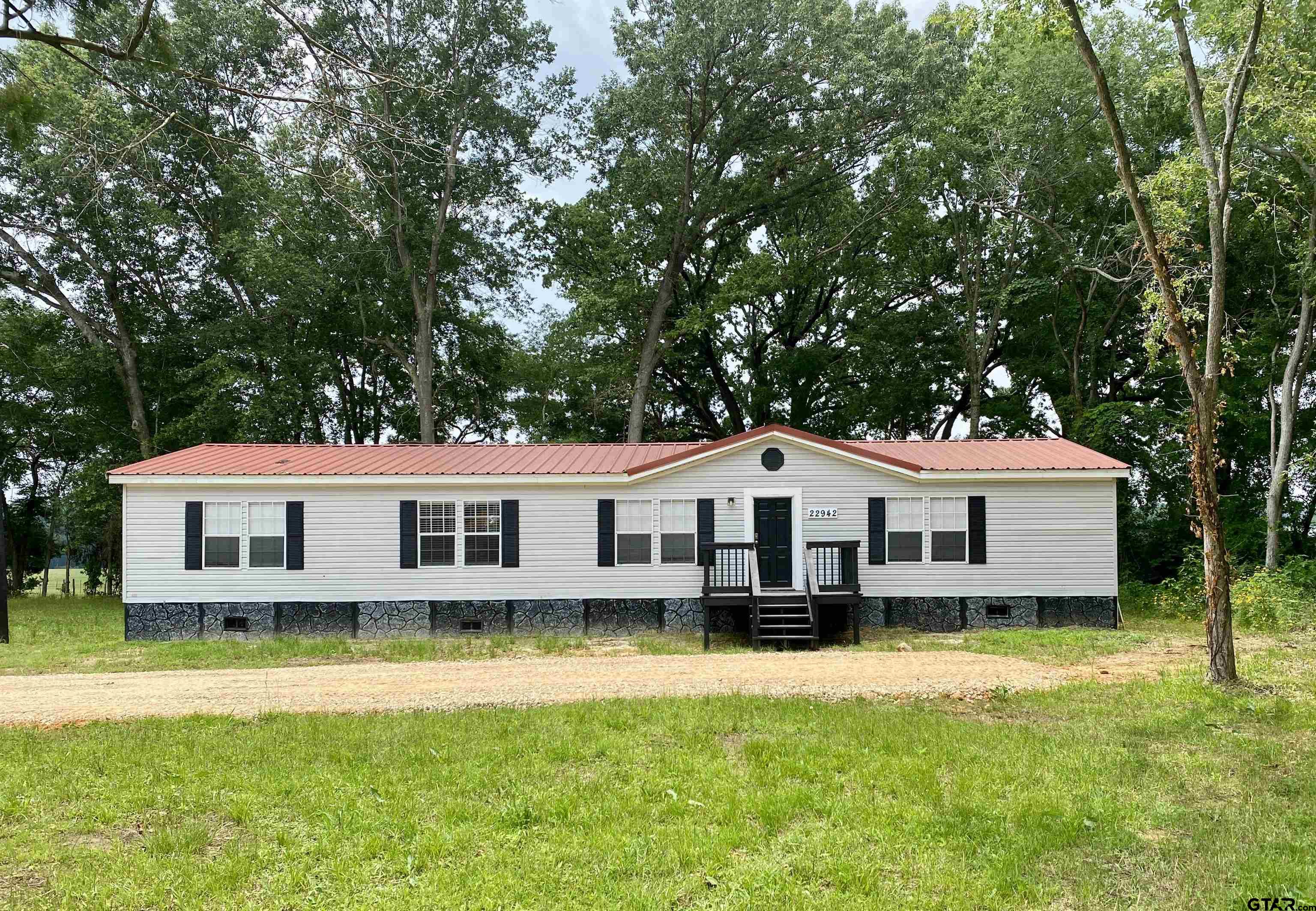 a front view of a house with a yard house and a swimming pool