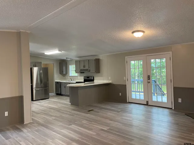 a kitchen with stainless steel appliances kitchen island wooden cabinets and granite counter tops