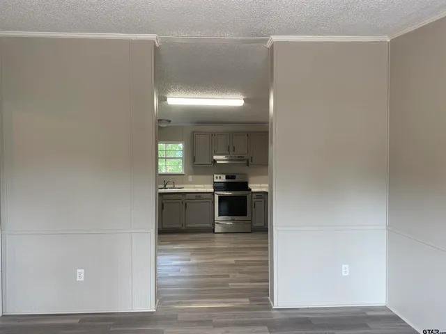 a kitchen with granite countertop a refrigerator and a stove