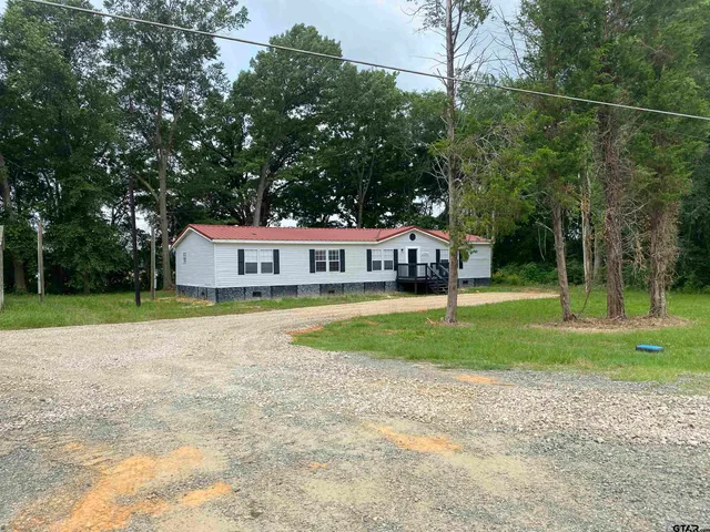 a house view with a sitting space and garden