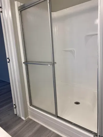 a bathroom with a glass shower door