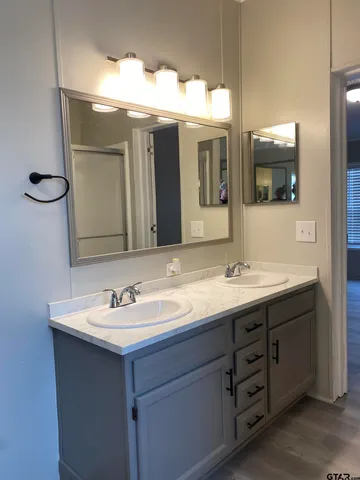 a bathroom with a double vanity sink and a mirror