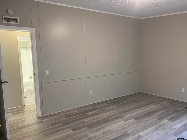 a view of a room with wooden floor