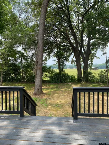 a view of swimming pool with deck and a yard