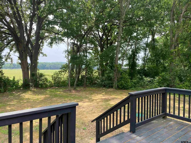 a view of a wooden deck with a backyard
