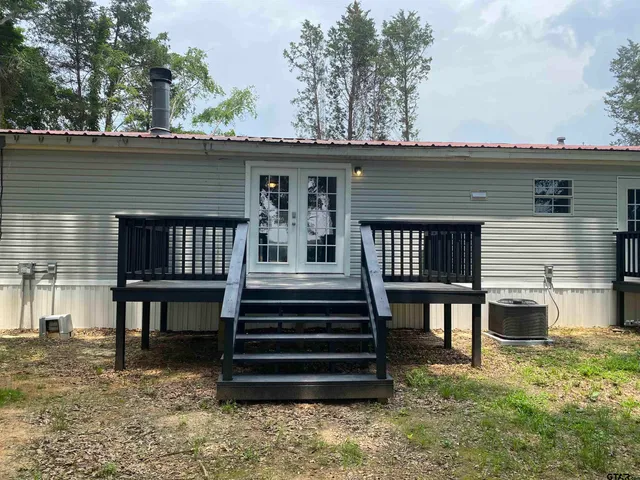 a view of a house with a balcony and furniture