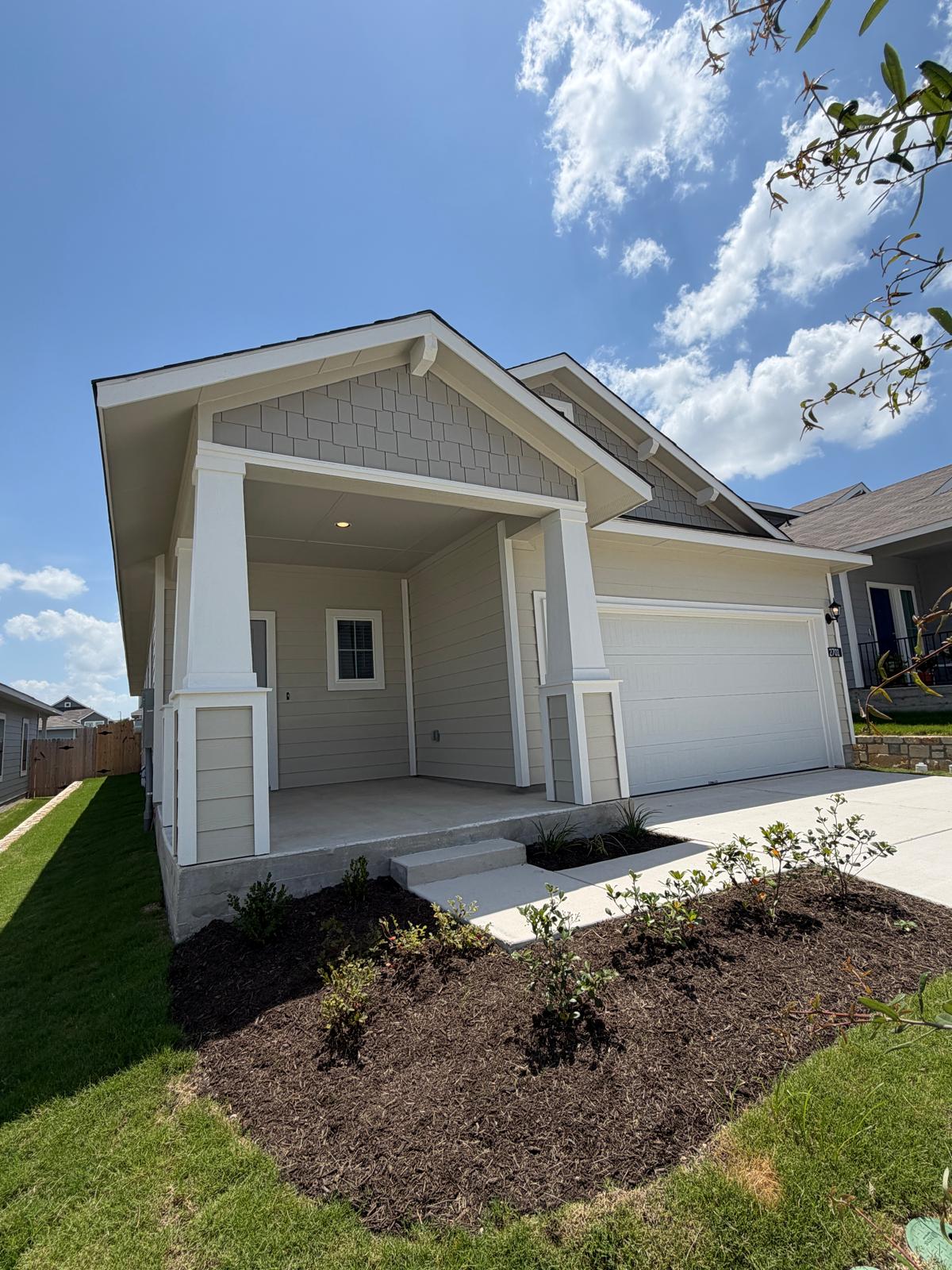 2701 Towy Road Manor, TX 78653 - Photo 2 of 35 A well-maintained facade with fresh landscaping and a welcoming covered porch.