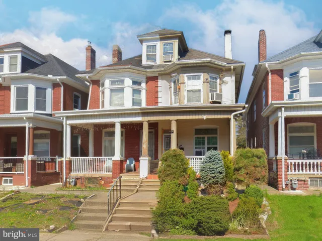a front view of a building with a garden