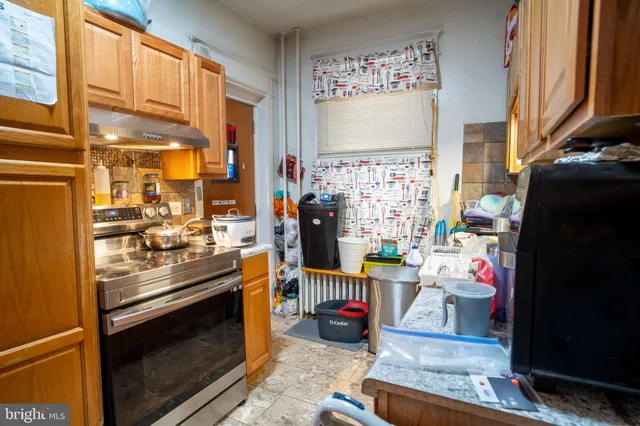 a kitchen with stainless steel appliances granite countertop a stove and a refrigerator