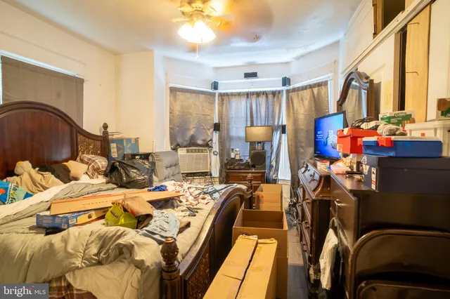 a view of a bedroom with furniture and a tub