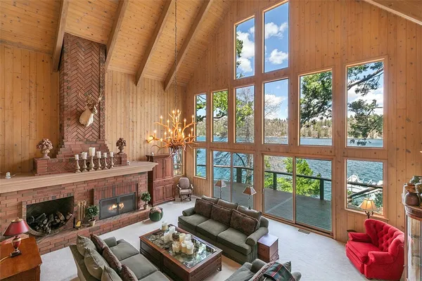 a living room with furniture and a floor to ceiling window