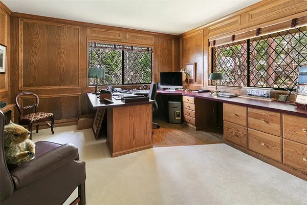 a view of a kitchen with kitchen island granite countertop a sink and a refrigerator