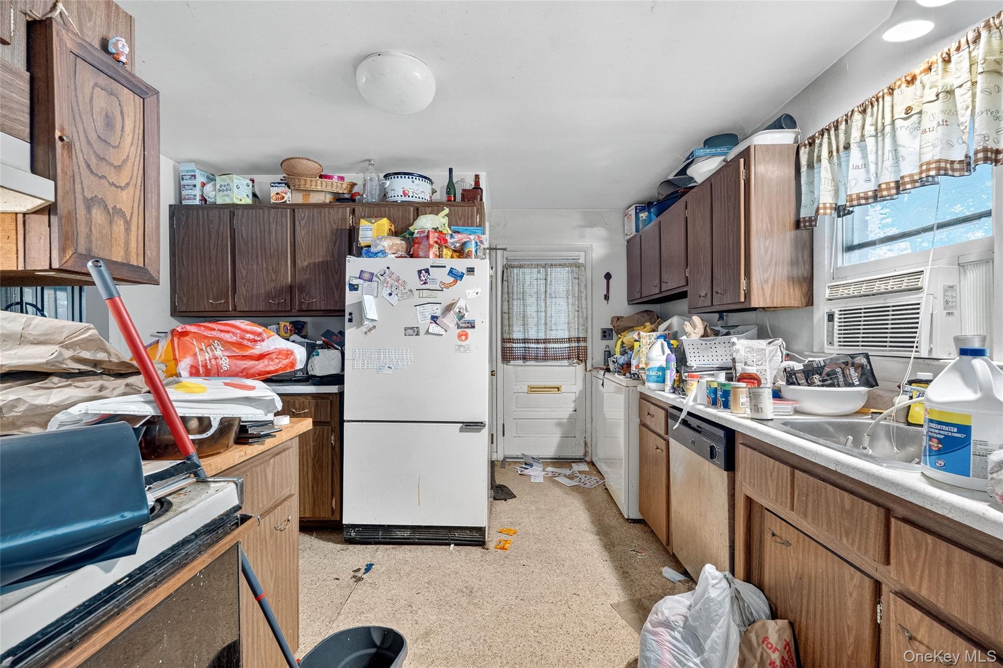 25 Russell Road Newburgh, NY 12550 - Photo 6 of 39 Kitchen with freestanding refrigerator, stove, dishwashing machine, light countertops, and cooling unit