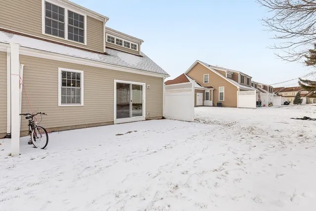 a view of house with snow on the side of road