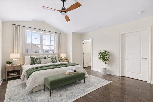 a bedroom with a bed and a potted plant