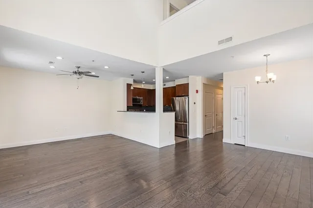 a view of a kitchen with a sink and a refrigerator