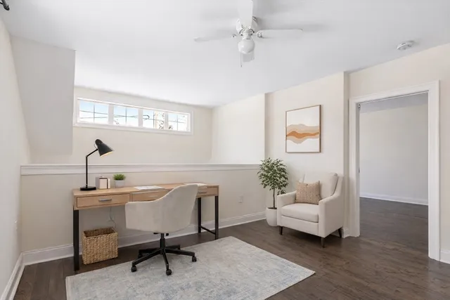 a spacious bedroom with a bed and wooden floor