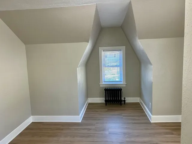 a view of a livingroom with wooden floor and furniture