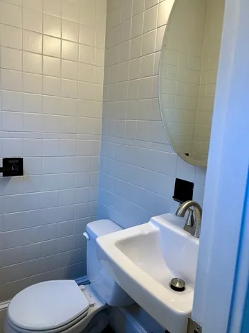 a bathroom with a sink a toilet and a shower