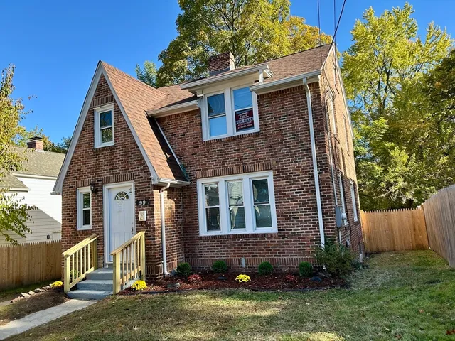 a front view of a house with a yard