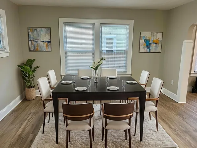 a view of a dining room with furniture and wooden floor