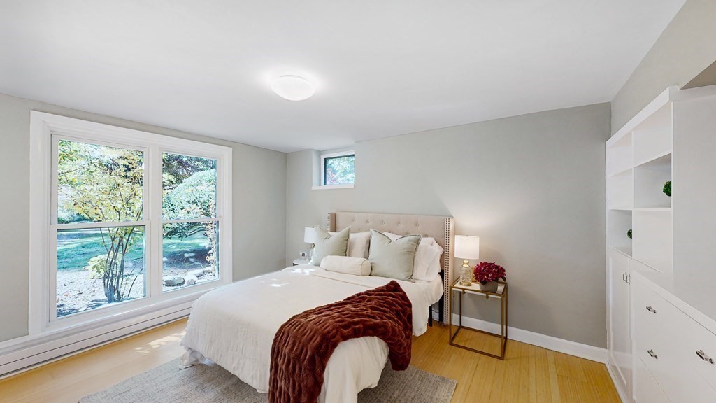 12 Ellis Road Weston, MA 02493 - Photo 20 of 42 a bed sitting in a bedroom next to a window